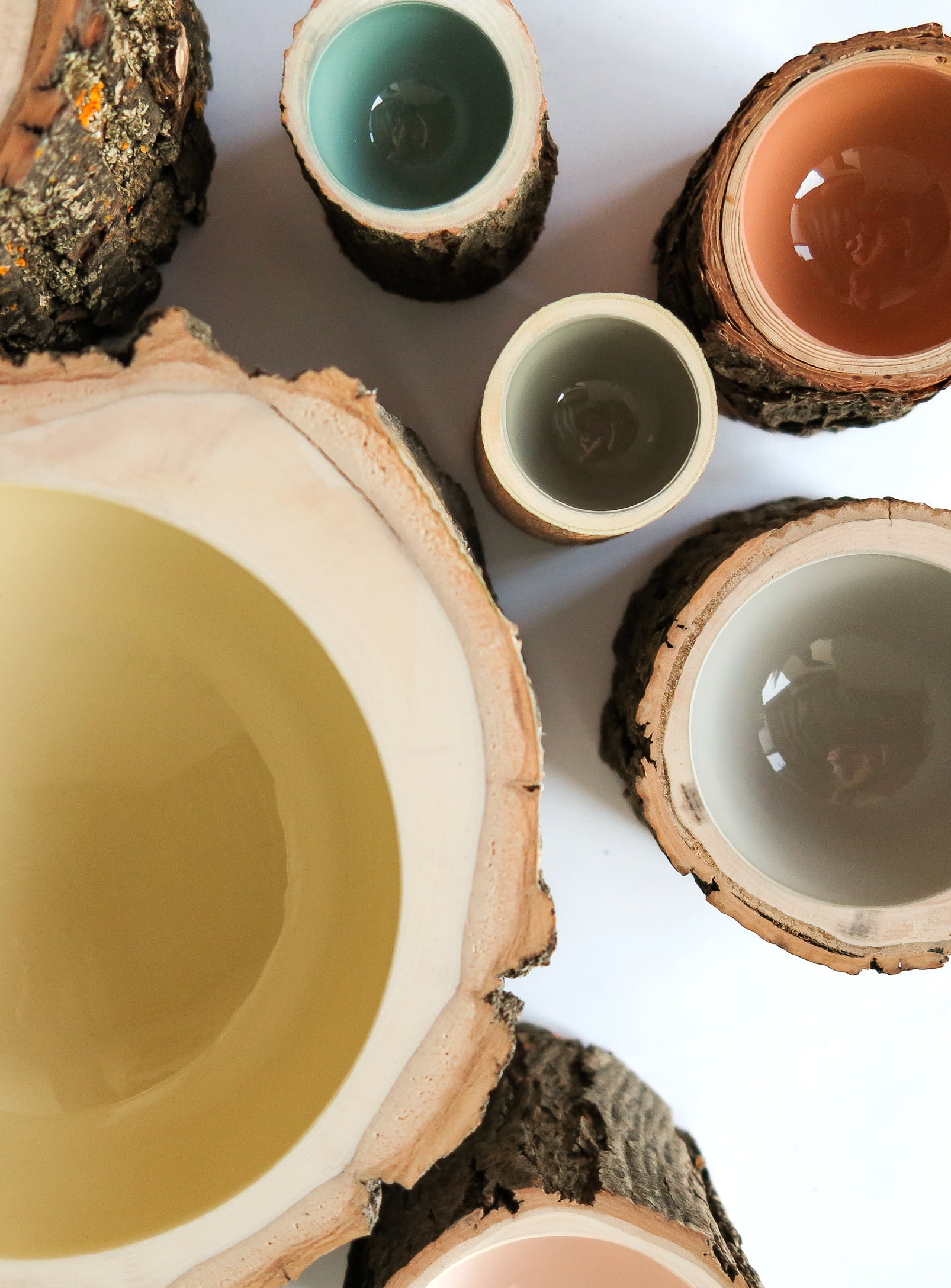 Top view of group of wooden bowls with varying pale colours.