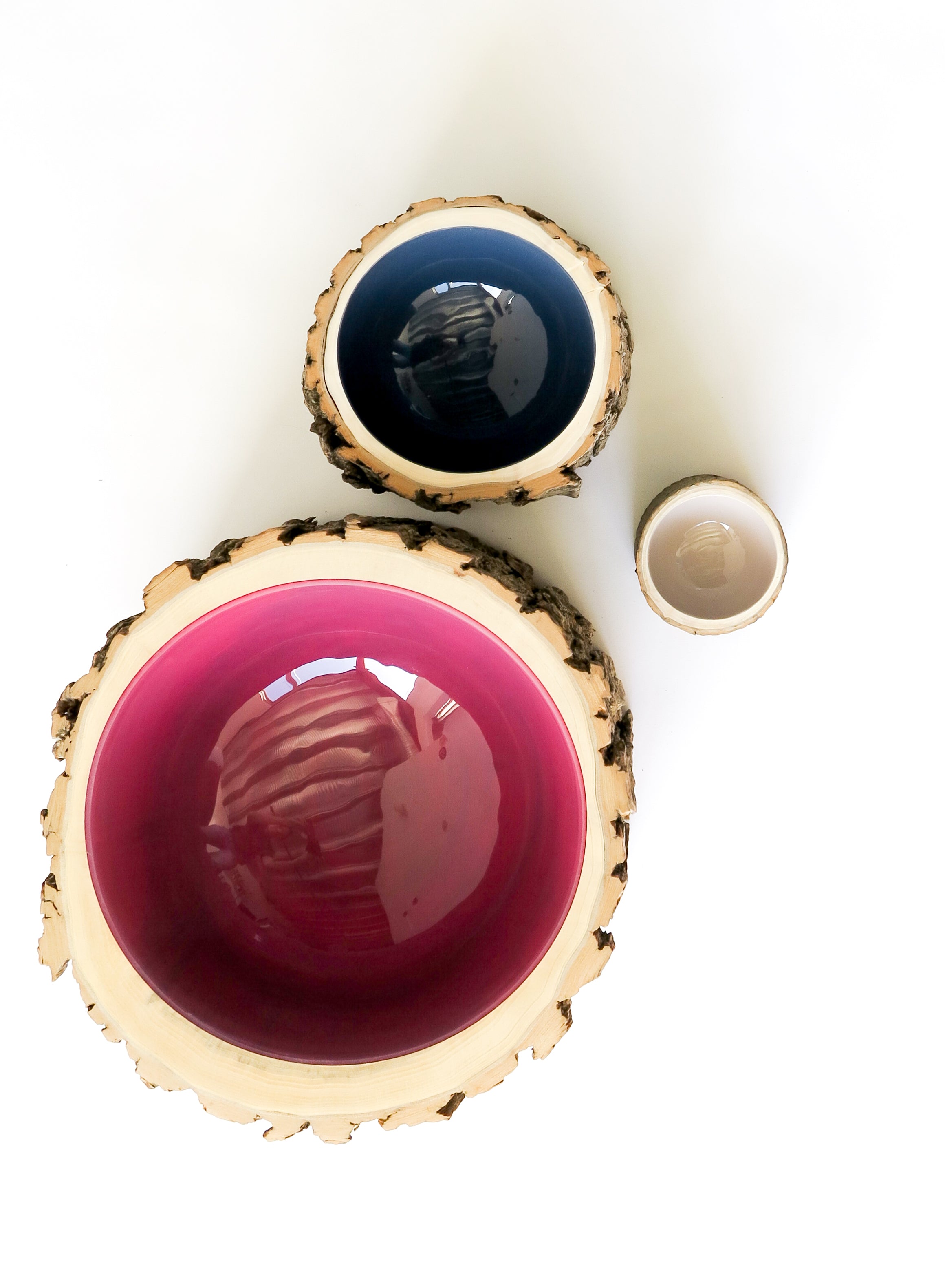 Top view of 3 Log Bowls by Loyal Loot in extra large, medium and small sizes. Glossy interiors are translucent deep magenta colour, navy and dusk.